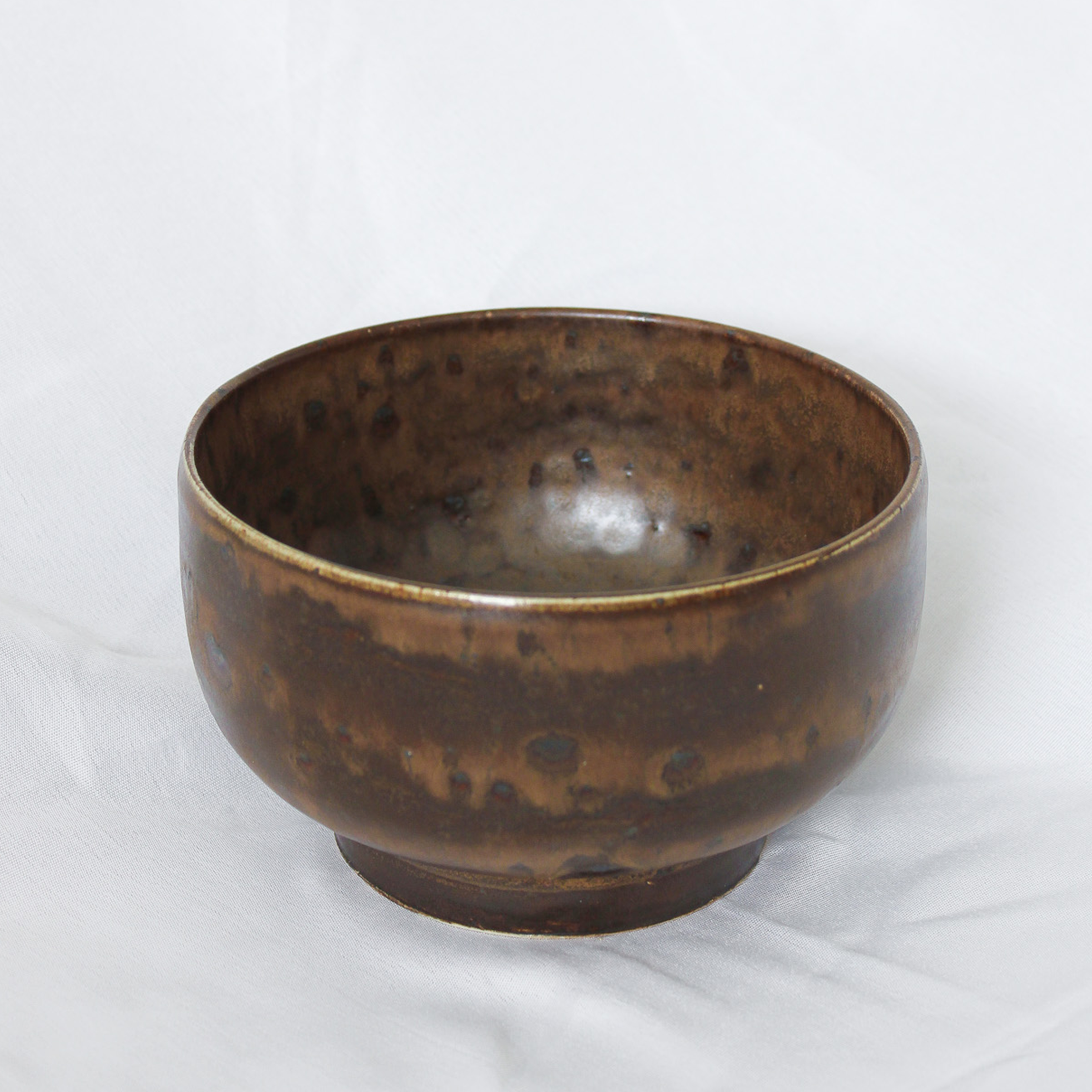 Brown ceramic bowl on a white background