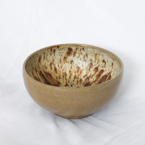 Brown ceramic bowl on a white background