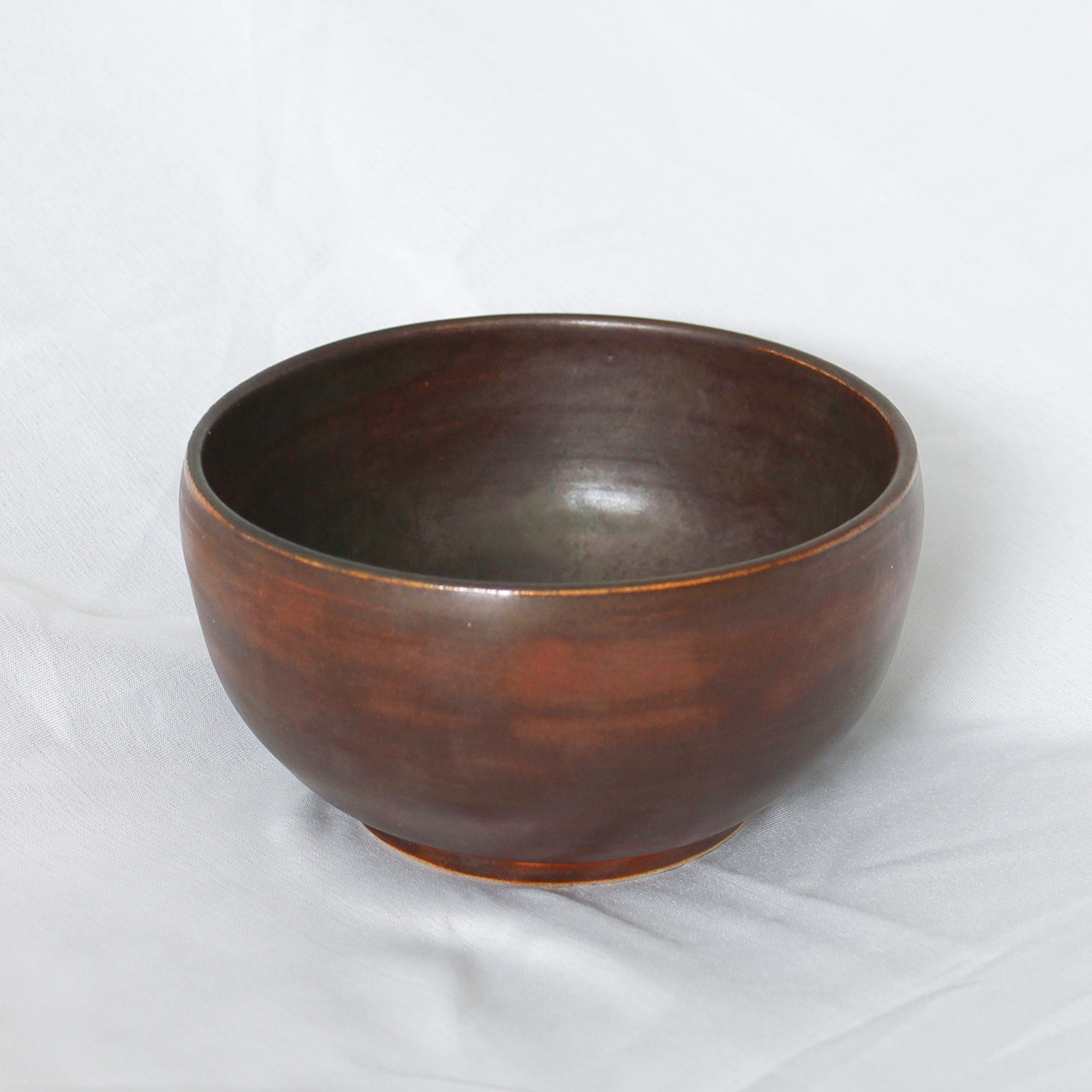 Brown ceramic bowl on a white background