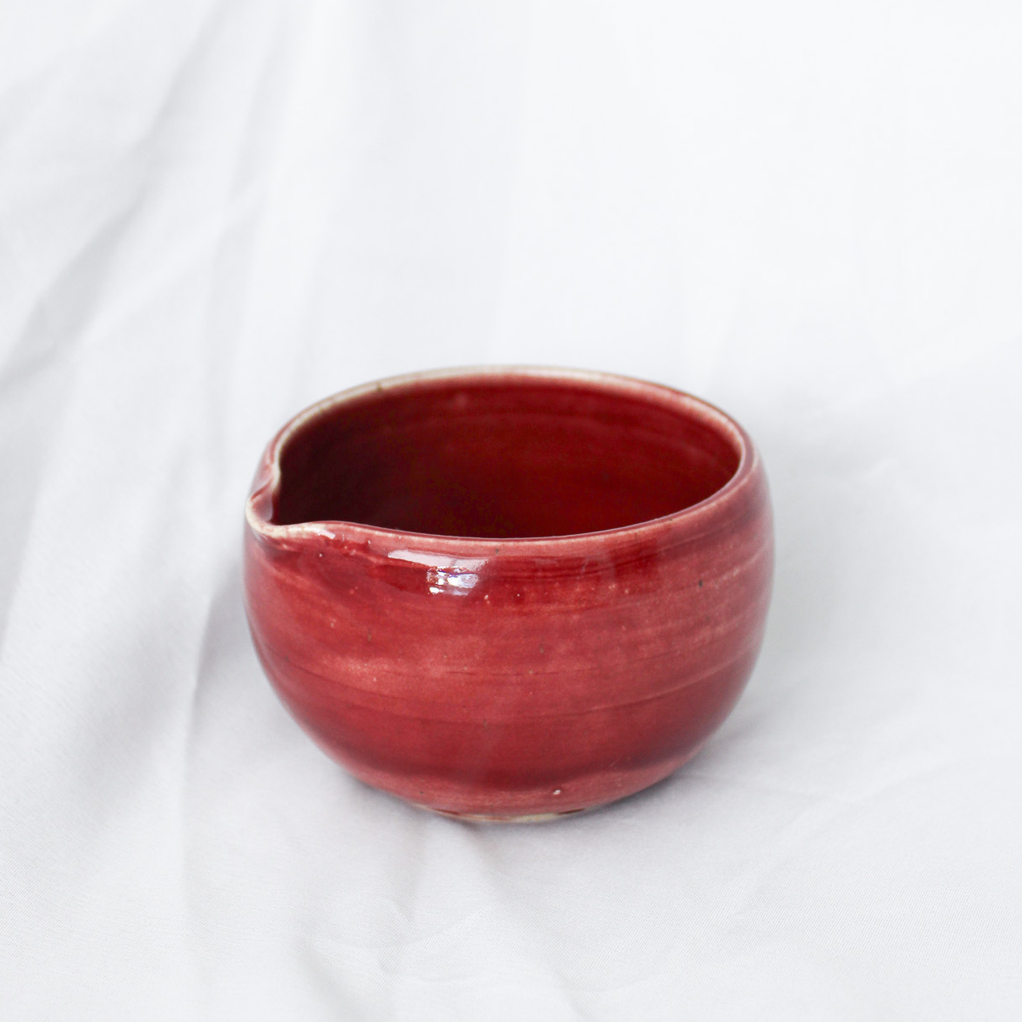 Red ceramic bowl on a white background