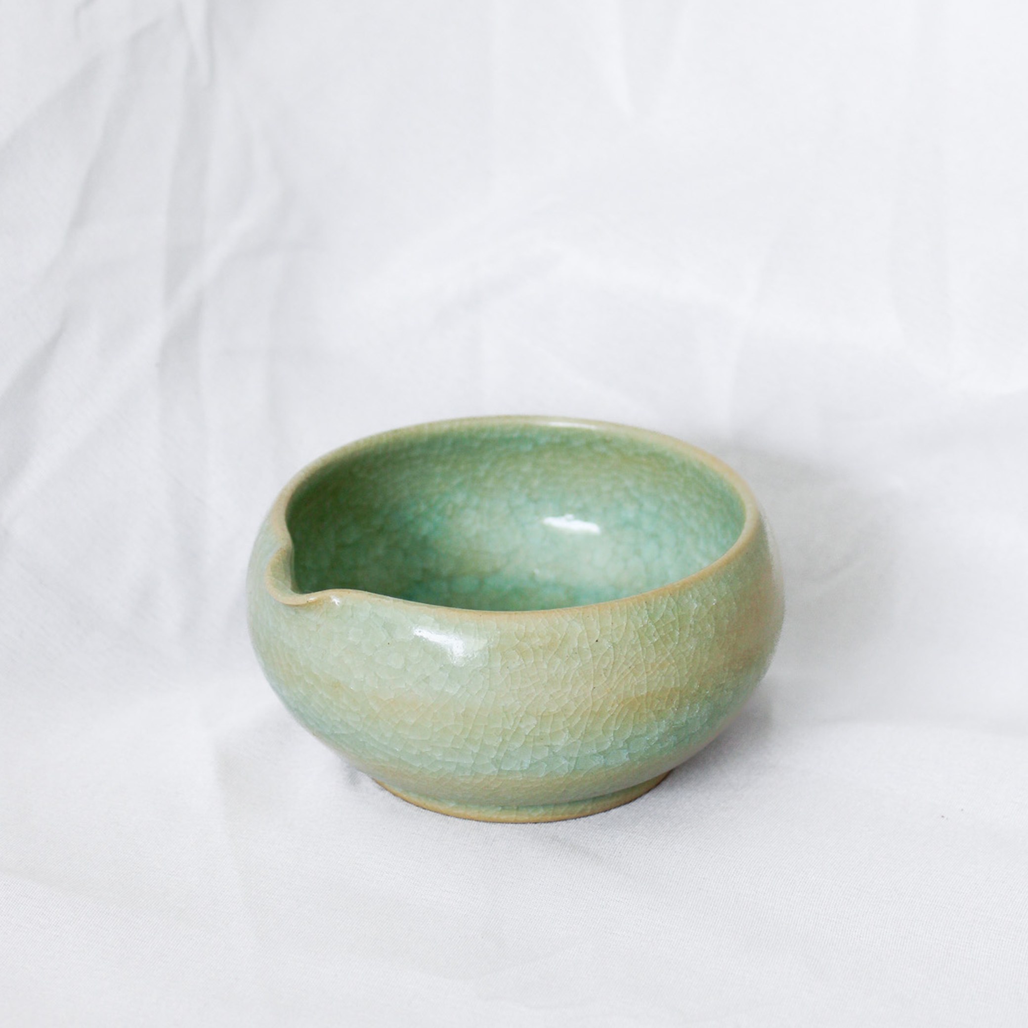 Green ceramic bowl on a white background