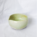 Green ceramic bowl on a white background
