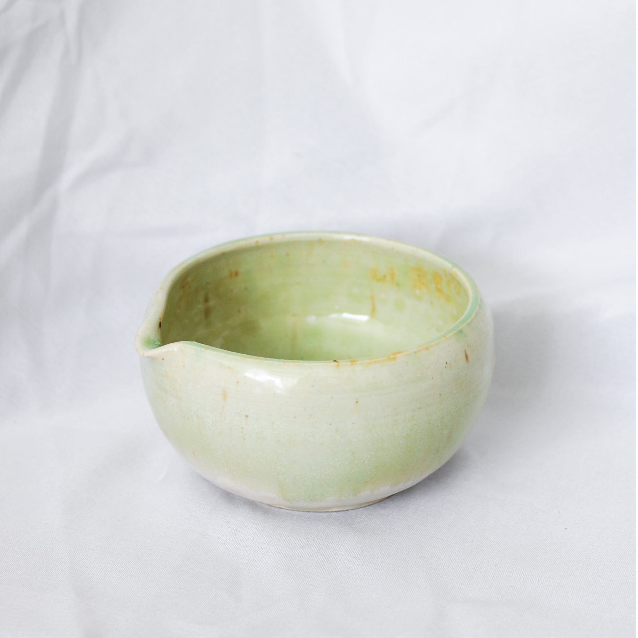 Green ceramic bowl on a white background