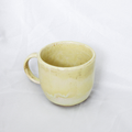 Yellow ceramic mug on a white background