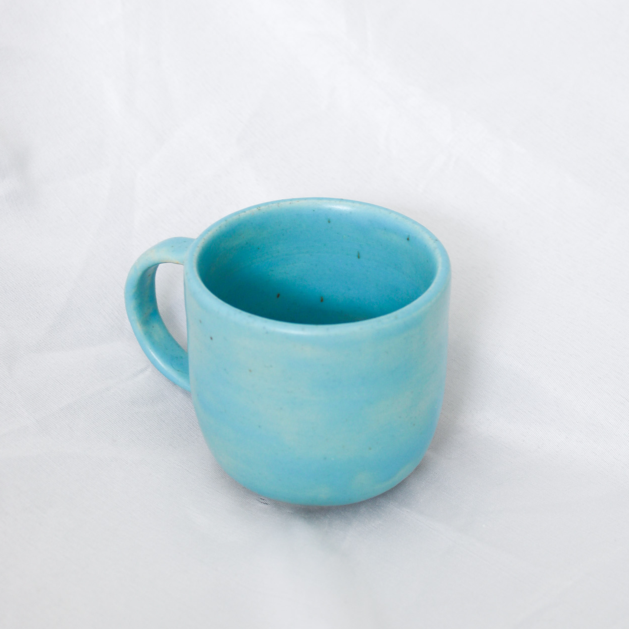 Blue ceramic mug on a white background