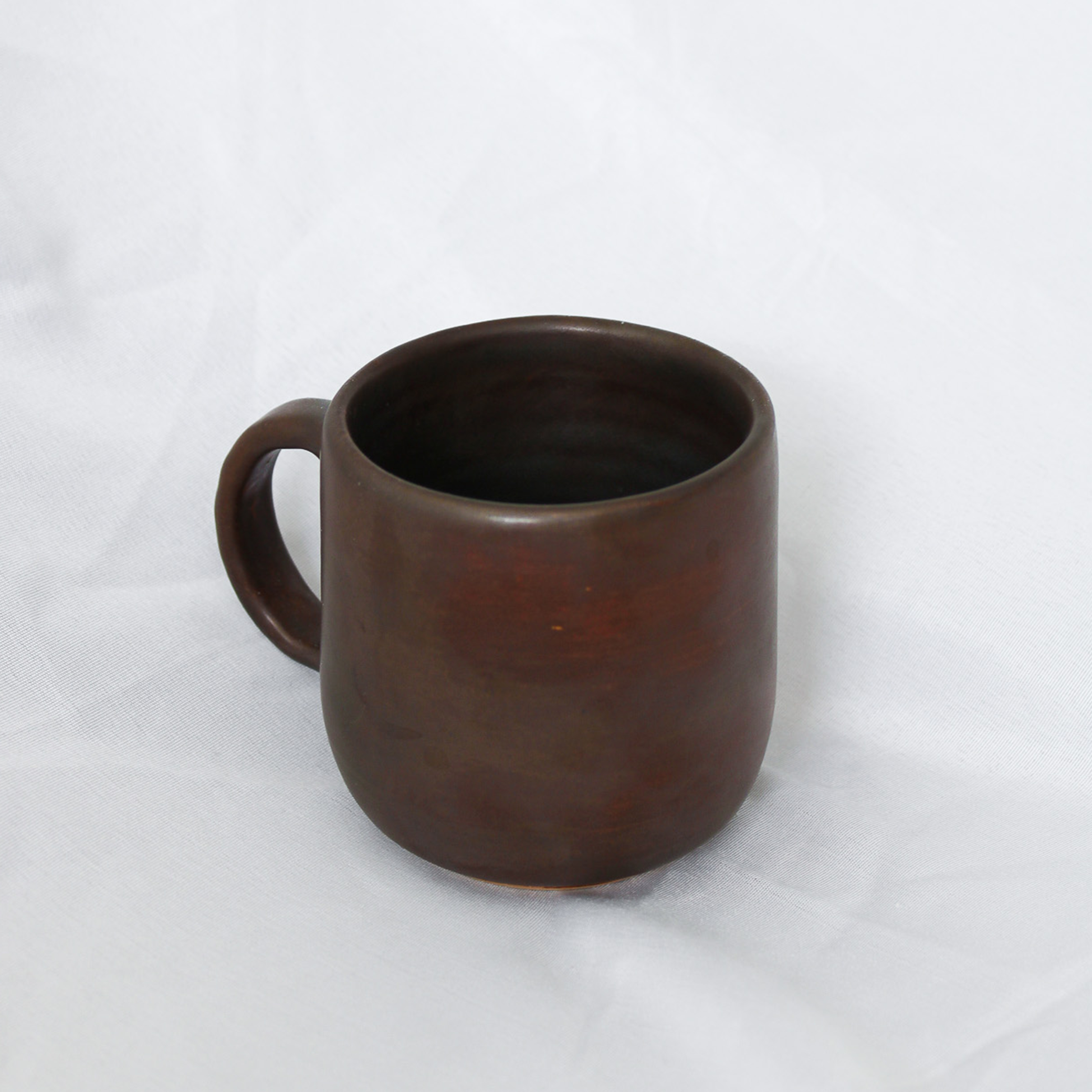Brown ceramic mug on a white background