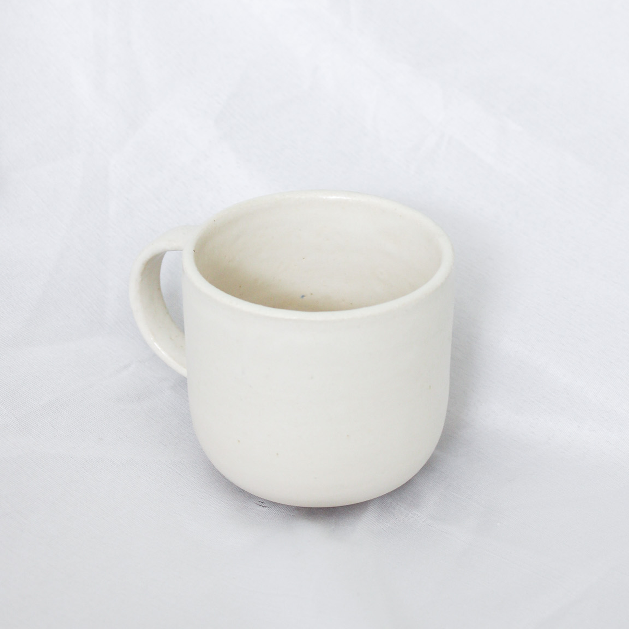 White ceramic mug on a light gray background