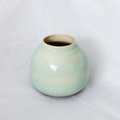 Green ceramic vase on a white background